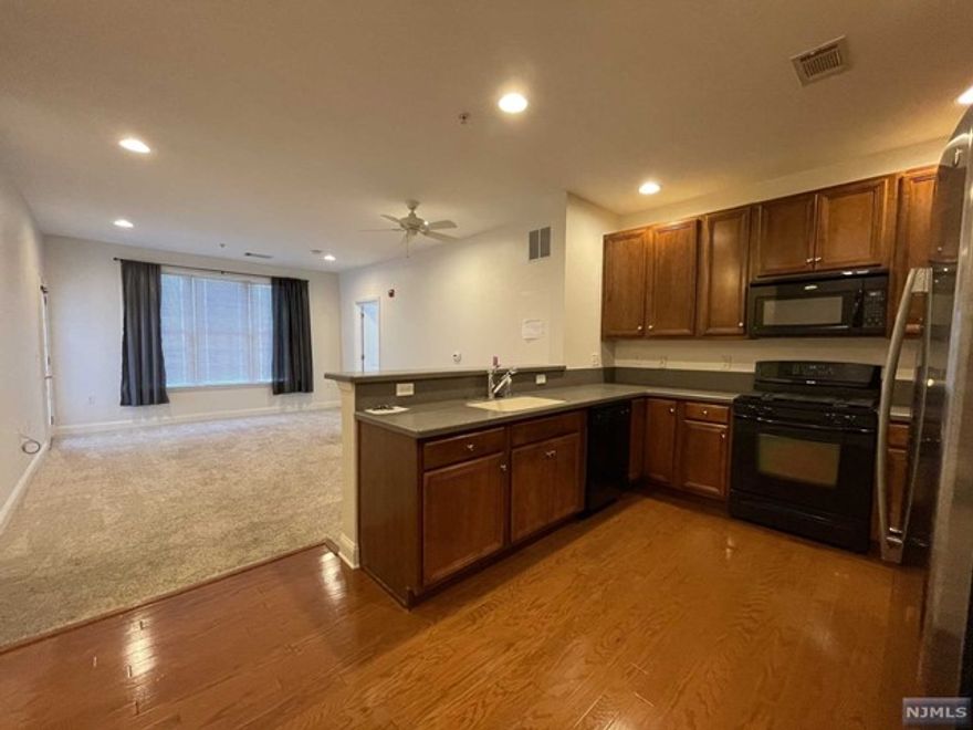 LIVE THE GRANDE LIFE! Featuring 2 bedrooms, 2 bath Gardenia model on the 2nd floor of elevator building. Each bdrm has its own WIC. Plenty of beautiful kitchen cabinets with corian countertops & breakfast bar. Spacious living / dining area. Laundry in unit. Balcony with courtyard view. One car garage assigned parking underneath bldg. Plus add'l parking. Enjoy all the amenities the Grande offers which includes 2 clubhouses, 2 pools, tennis courts, fitness ctr, billiards rm, conference rms, party rms & much more! Great location near all major highways, shopping & restaurants! Low Taxes Only $5619. PET POLICY- MAX 2 PETS PER CONDO -35LB WEIGHT LIMIT PER PET. BEING SOLD AS-IS - NO KNOWN DEFECTS.