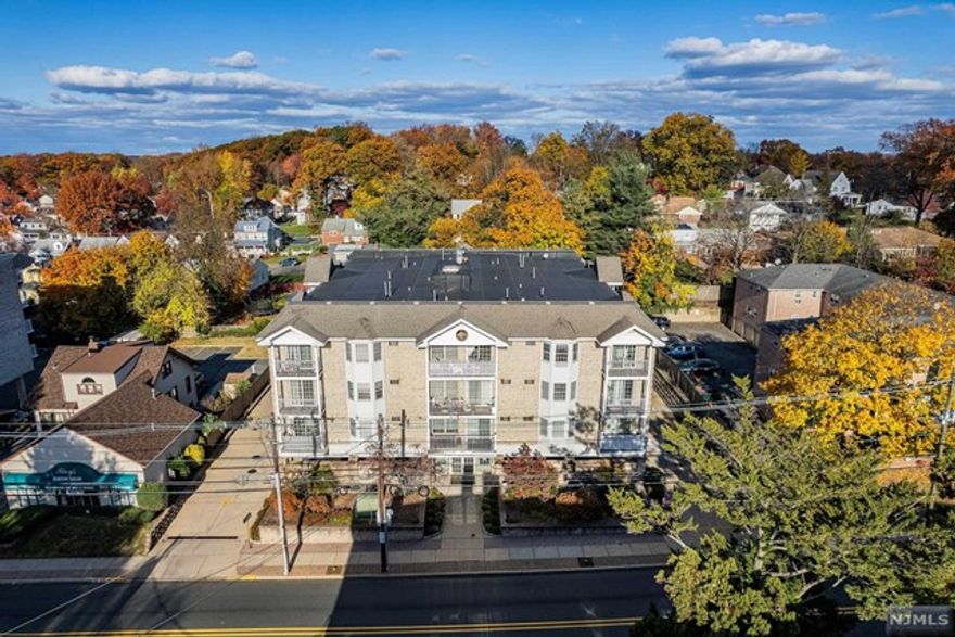 Fabulous opportunity to own a spacious two bedroom, two bath condo in a newer elevator mid-rise! This 1150 square foot unit built in the 2000's features a great layout! The formal entry foyer greets you and opens to the oversized living room/dining room with bay window. Eat-in kitchen with sliding glass doors to terrace, primary suite with en-suite full bathroom, and second bedroom and full bath complete this lovely unit. Desirable building with great curb appeal is conveniently located within close walking distance to express NYC transportation and super close to HUMC, highways and shopping! Additional features include two assigned covered parking spaces (tandem), in unit laundry, beautiful common areas, low maintenance, and bright Southern exposure! Two pets under 16 pounds are permitted! This one checks all the boxes--don't miss it!