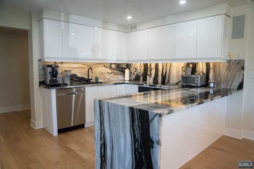 Let this extraordinary hi-rise luxury experience enlighten you the moment the valet service opens your car door and welcomes you home. With a 24hr doorman, fitness center, outdoor heated pool, Tennis courts and personal secure storage space all included in you amenities. This first floor completely renovated corner unit. Featuring over 1,600 sq feet with 2 very spacious bedrooms, an open floor plan with Italian designed Kitchen, Panda white quartzite, high end Jenn-Air appliances, undermount sink, built in refrigerator followed by a waterfall peninsula that flows into the dinning room and an oversized living room with a 78" fireplace and a corner bar looking over at your oversized balcony and professionally landscaped grounds. Close to NYC transportation, shops, supermarket and fine restaurants. All hallways and elevators building are being completely renovated and will be finished on 2023.Parking for a fee. Occupied 24hr Notice. Use SHOWING TIME!