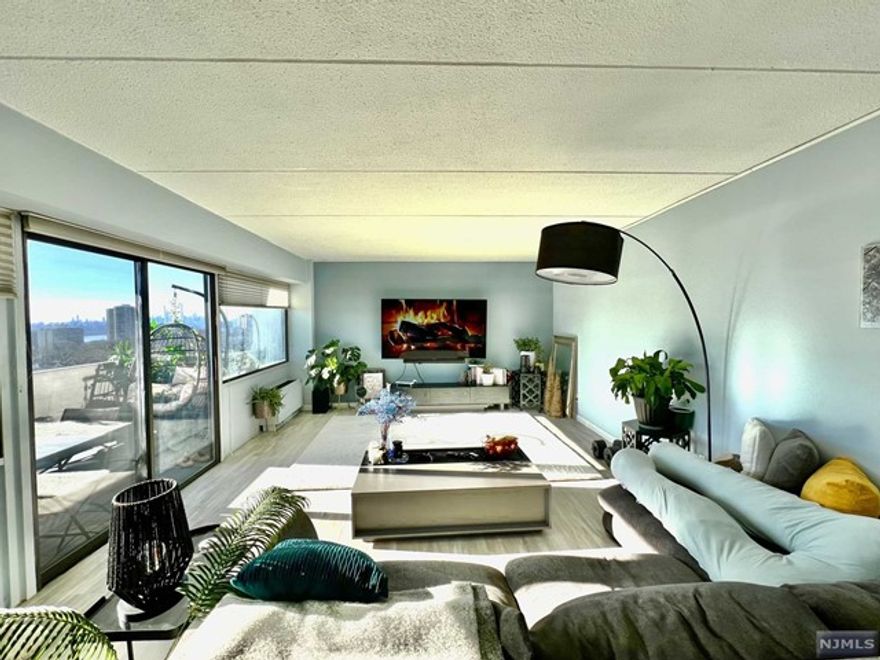 Great Location, walking distance to Main Street and shopping district, Post Office, New York City transp., practically outside of the building ---This Corner Unit has a SPACIOUS ONE Bedroom facing South, Large Living Room / Dining room / kitchen are FACING EAST with a large BALCONY off the Living Room --- UNIT is very sunny with beautiful SKYLINE VEWS of MIDTOWN MANHATTAN----Unit has Updated Kitchen, 1.5 bathroom, new hot water heater, NEW FLOORING throughout, BR has 3 double closets, building has 24 hours doorman, and security, package service, WASH MACHINE AND DRYER IS ON THE FLOOR W/COIN/CARD.