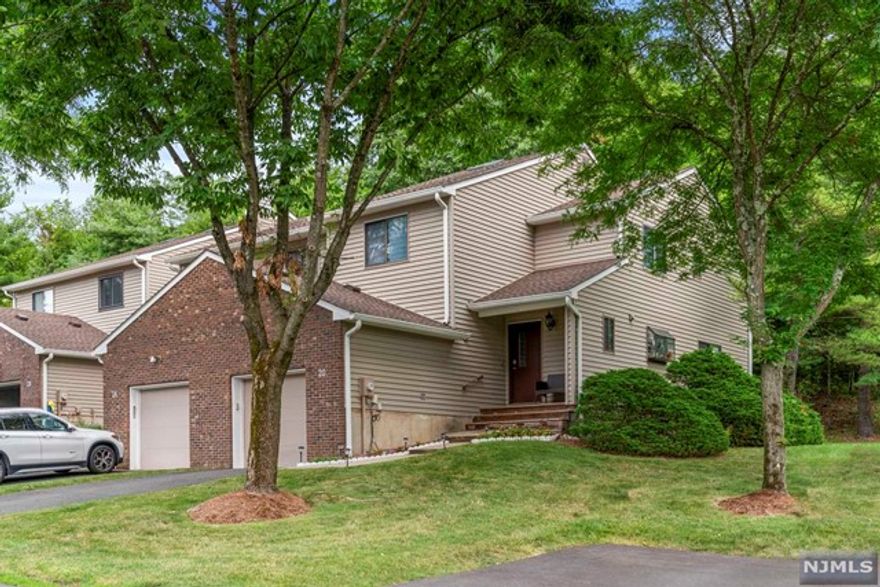 Opportunity knocks with this fabulous end unit townhome in the Langdale Community. Tucked away in a serene cul-de-sac, it boasts a private wooded backdrop. Inside, discover three bedrooms and 2.1 baths, including a primary bedroom with a primary bath and two closets. The spacious main level features a sizable kitchen with stainless steel appliances, a family room with a wood-burning fireplace, and a dining room with sliders leading to a newer deck a perfect spot for outdoor relaxation. The fully finished basement offers versatility, housing a rec room, office, and crafts area. Conveniently located near the middle school, and town pool. This home combines comfort, convenience, and low maintenance fees.