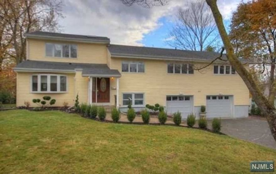 Super location !Spacious 5 bedroom SPLIT LEVEL that has been updated throughout.. the 5th Bed room is Generously sized, sun-drenched room that can be used as a GREAT ROOM ON THIRD FLOOR ...a room with high ceiling and skylights. Updated kitchen with door to patio and fenced rear yard, all (3) full bathrooms are updated, hardwood floors throughout, central air. Lower floor has laundry, storage and access to a 2 car attached garage. Truly in move in condition! Great schools . Great landlords and very close commute to NYC.. Don't miss this one!