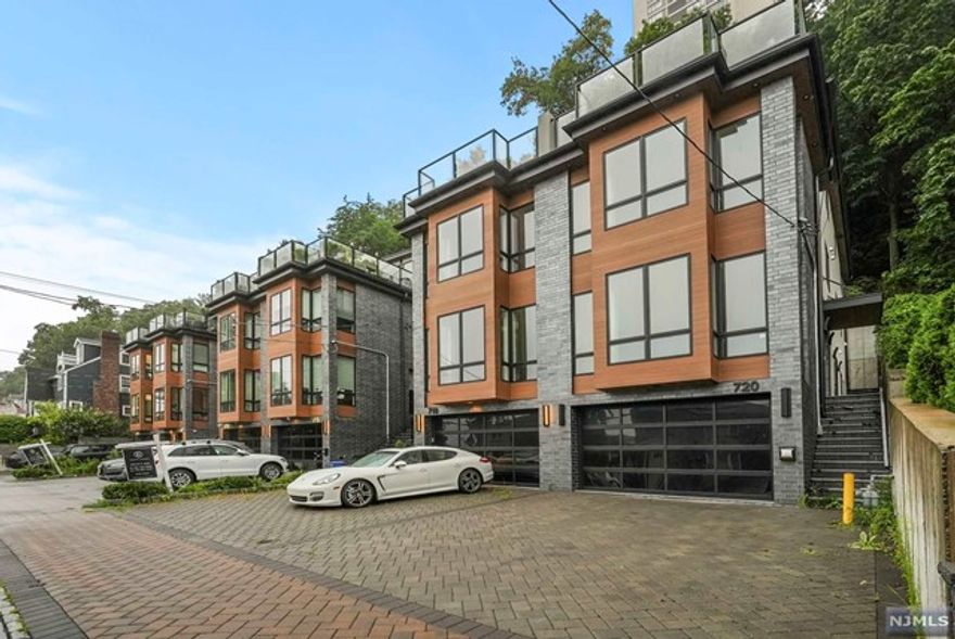 Luxury Oasis for lease, in a 3 year young corner unit 4 level Duplex with approx 4,000 sq ft of living space, this 4 bed 5 bath includes a rooftop deck with an entertainment level and wet bar with views of the NYC and GWB. 2 oversized skylights, full bath on the 4th level, 3rd level: Master Bed Rm & bath, 2 additional ensuite Bed Rm & a bath, full size W/D and walks out to the backyard patio. 2nd level: Gourmet Kitchen (Miele Kitchen Appliance Packages) w/large open bright rooms leads to the Dining & Living rm w/a Fireplace and Powder Rm. Lower level: Rec Rm & Bath Rm, large walk-in closets. Over-Sized one car garage & 2 cars driveway parking space. Enjoy private living with access to NYC buses and ferries minutes away.