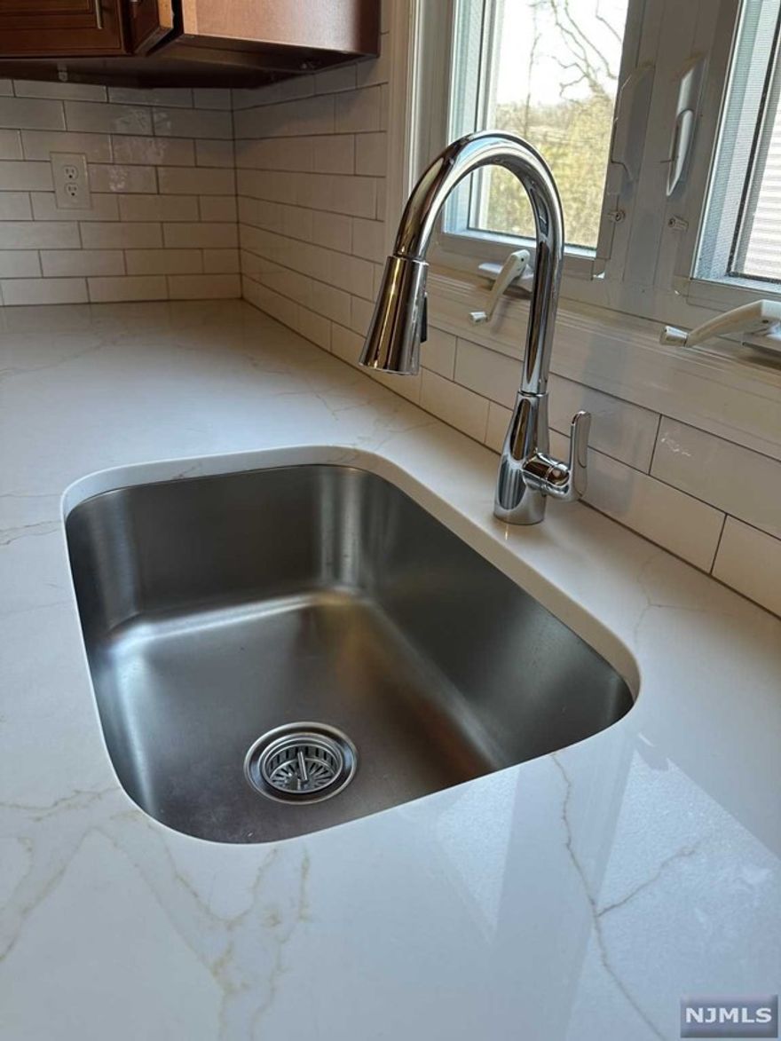 Beautifully renovated 1st flr apt. shinny hard wood floors throughout. gorgeous custom kitchen with granite counters and brand new stainless steel appliances. TWO brand new full baths! C/A, laundry hookups and driveway parking. Close to NYC transportation, hwys ans shopping.