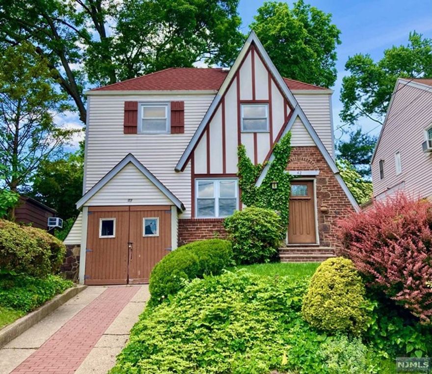 Commuters Dream Tudor. Walk to NYC city transportation. Spacious renovated light-filled home. Newly renovated kitchen and bathrooms. Central Air/Heat. Full Finished Basement. Hardwood Floors throughout. Newer windows. Newer gas range and microwave. Washer & Dryer hookups. Oversized one car garage and driveway. Oversized deck leading to spacious yard. Beautiful tree-lined residential street.