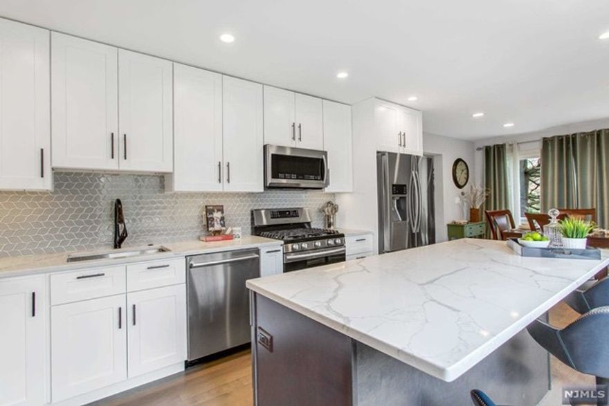 LOOKING FOR THE WOW FACTOR... YOUR SEARCH IS OVER! TOTALLY RENOVATED JAW DROPPING 4 BR 3 Bth END UNIT in Highly Desirable BROOKSIDE MANOR! Fabulous Location across from Clubhouse! LR/2 Sty Fpl! DR/SGDs Dk! New Sleek Open Chef's Kitchen w/Huge Center Isl, 42" White Designer Cabinets, Farm Sink, Quartz, Stunning Custom Tile Backsplash & Top of the Line SS Appliances! 3 New High-End Quartz Bathrooms! New H/W 1st Fl & Refinished H/W 2nd Fl! Entertain in Style in this Chic Bright Open, Townhouse. 1st Fl Guest BR/Den w/Amazing New B/SS accessed from BR/Den & Foyer! Huge 2nd Fl Owner's Suite w/Picture Window, Skylight, Walk-In Closet & Sleek New Owners Bathroom w/Huge Shower & Double Vanity! Top Drawer New Hall B/SOT w/Two Vanities & Fabulous Tile Work! Two Other Bright BRs w/Windows Galore and Double Closets! New Finished Bsmt w/Lndry! Enjoy Pool, Walking Paths, Tennis, Playground & Club House! Convenient to NYC Transportation, Parks & Ski Trails! Top Rated Schools! So Special! Hurry!