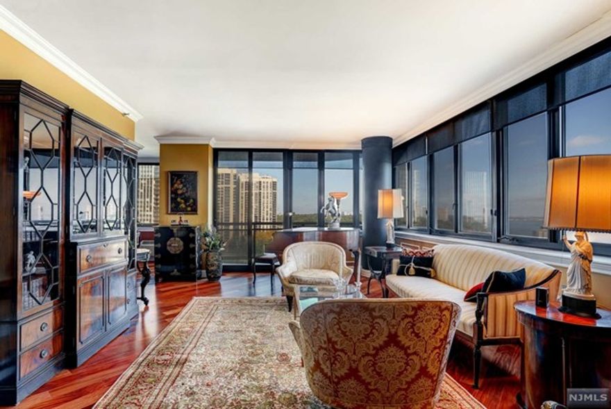 Magnificent completely renovated largest 2br/2bth condo in prestigious Carlyle Towers. Stunning panoramic Hudson river and GW bridge views. Brazilian cherrywood flooring and custom moldings throughout. Custom kitchen with granite counters, task lighting and exhaust hood. Guest bath has onyx floors and intricate tile work not to be missed! The main bath ensuite is ENORMOUS with custom cabinetry ,marble and tile work...mood lighting completes this spa-like retreat! There is a SPECTACULAR walk in closet as well as a double closet in the main bedroom...both with high end custom fittings. Solid wood doors with specially crafted hardware and laundry in unit with Bosch washer/dryer add to the luxury... No expense was spared in renovating this elegant and incredible home in the sky!REDUCED PRICE!!! MOTIVATED SELLER!