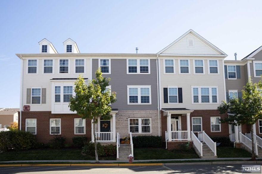 GORGEOUS TOWNHOUSE located in Liberty Square at Wesmont Station. This rare Manchester unit features 3 bds, 2.5 bth + den with 2 car garage with 1935 sq ft of living space. Beautifully decorated with luxurious wallpaper in key rooms, hardwood floors, crown molding, chair rails, iron rod staircase and window trims. The gourmet style kitchen has stainless steel appliances and granite countertops. Living room boasts 9 ft ceilings, gas fireplace with marble surround and in ceiling surround speakers. The master suite has a cathedral ceiling and a bath designed for luxury, Italian marble granite, large shower, jacuzzi tub, dual sinks and in-wall medicine cabinets. All closets have been fully customized throughout the house to maximize storage. And for outside living, the 200 sq ft deck offers unobstructed views of the neighborhood. An ideal location with a playground, ball field, grocery store, Dunkin Donuts and is also walking distance to NJ Transit Trains and Buses.