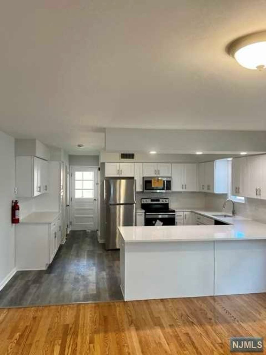 THE SEARCH ENDS HERE! STEP INSIDE THIS COMPLETELY RENOVATED 3 BEDROOM 1.5 BATHROOM DUPLEX AND PREPARE TO BE AMAZED. FROM THE ENTIRELY NEW MODERN KITCHEN TO THE GLEAMING BATHROOMS AND RECENTLY INSTALLED FLOORS NOT ONE INCH OF THIS APARTMENT ISN'T BRAND NEW. IF THAT WASN'T ENOUGH THIS UNIT INCLUDES A ONE CAR DRIVEWAY AND USE OF REAR YARD. UNIT COMES COMPLETE WITH WASHER/ DRYER HOOKUPS, LANDLORD WILL PURCHASE A WASHER/ DRYER FOR AN ADDITIONAL $150/MO. **photographs shown are of unit B, unit A is exactly the same except the first floor floor is the gray floor seen in the kitchen not hardwood**