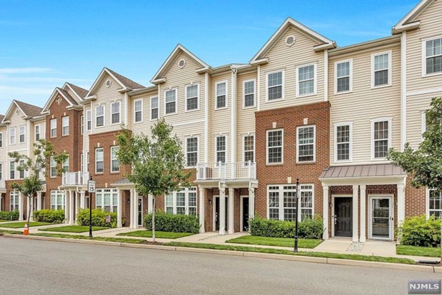 Luxury living at Liberty Square at Wesmont Station only 10 miles of New York City! This elegant townhome features 1771 sq. ft. on 3 levels with hardwood floors on the main level, an open floor plan, gourmet kitchen with stainless steel appliances, granite countertops & a breakfast bar, a formal dining room,& living room with a balcony, plus a powder room on this level. An open stairwell leads to the 2nd level with a gracious private suite with a walk-in closet, shower & large soaking tub & double sink vanity, plus 2 additional bedrooms, one with a walk-in closet, a full hall bath & laundry center. The ground level features front and rear entrances, an attached garage and storage closet. This is an ideal commuter location. The complex offers a playground, ball field, grocery store, a Dunkin Donuts all walking distance to NJ Transit Trains and Buses. Easy living & a luxury lifestyle in the wonderful town of Wood Ridge! **ALL NEW CARPET INSTALLED 10/6/21**