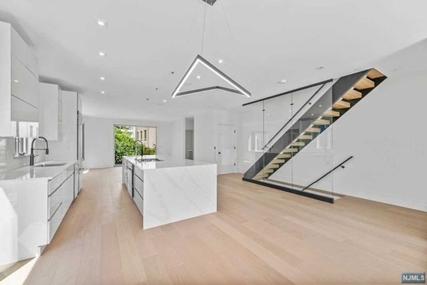 Welcome to 10 Hooks Lane, A Modern Contemporary Design Townhouse Encompasses A Sleek Exterior Design with Black Brick, Aluminum Clad Bump-Outs, Oversized Anderson Windows, and Black Aluminum Glass Doors....Approximately 4000 Sq Ft over 4 Stories with Glass Enclosed Rooftop Deck with NYC and Hudson River Views....Open Concept on Main Level with 9 ft Ceilings, European Style Kitchen with Oversized Island, Living Room with Cove Lighting and Linear Gas Fireplace, Dining Room, and Trex Deck....Primary Suite with Walk In Closet and Spa Like Bath, Two Additional Well Appointed Bedrooms with Full Bathroom in Hallway....Loft complete with Wet Bar and Half Bath with Sliding Doors opening out to Rooftop Deck....Ground Level with 2 Car Garage, Recreation Room, Bedroom/Office, Half Bath....Additional Features Include Private Elevator, White Oak Floors, Multi Zone HVAC, Camera Ready, Multi Zone Speaker System, Smart Home Ready....