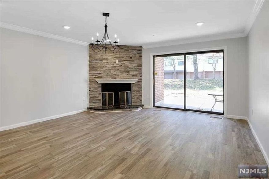 Welcome to the gated community at Glenpointe. This unit offers over 2000 sq ft of living with 3 bedrooms, 2 full bathrooms & a half bathroom. This ground-floor unit has been remodeled with all new flooring throughout, newer kitchen & quartz countertops. The open floor dining room & living room with wood fireplace also features sliding door to patio. Master bedroom feature on-suite bathroom & walk-in closet. Large 1 car garage with outdoor space and plenty of guest parking nearby. This luxurious community features amenities including an outdoor pool, tennis courts, & club house. Steps away from Teaneck Creek Conservatory & Overpeck County Park with easy access to mass transportation, NJ Turnpike(I95), Routes 80, 4, and 46.