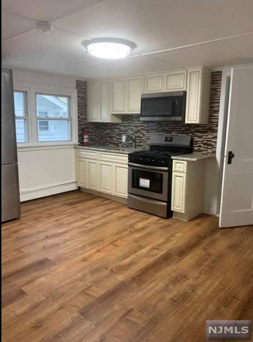 Updated second floor one bedroom apartment in Clifton, Updated kitchen with granite counter top, stainless appliances. Hardwood floor closet space
