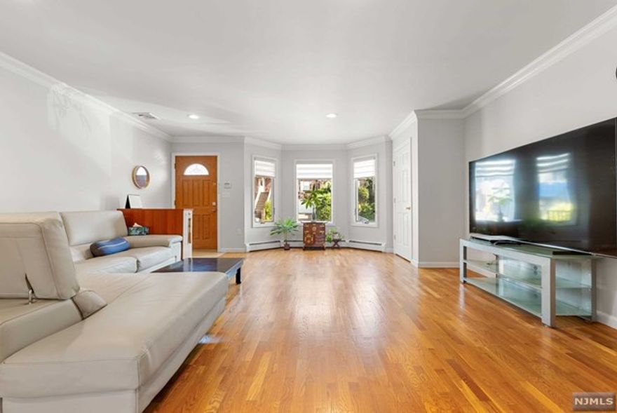 This beautifully maintained 2007 duplex model is located on a highly sought-after dead-end street in Palisades Park, walking distance from Broad Ave and to Koreatown and the express bus to NYC. The first floor features elegant crown molding in the living room, a convenient half bath, a dining area, and a modern kitchen with granite countertops. Upstairs, you'll find two spacious bedrooms, a full bath, a laundry area, and a master suite with crown molding and an en suite bathroom, complete with a jacuzzi tub. The above-ground lower level offers a separate entrance, two-car garage, fireplace, full bath, and a summer kitchen. Situated close to shopping, restaurants, highways, and just minutes from the George Washington Bridge, this home combines convenience with charm.