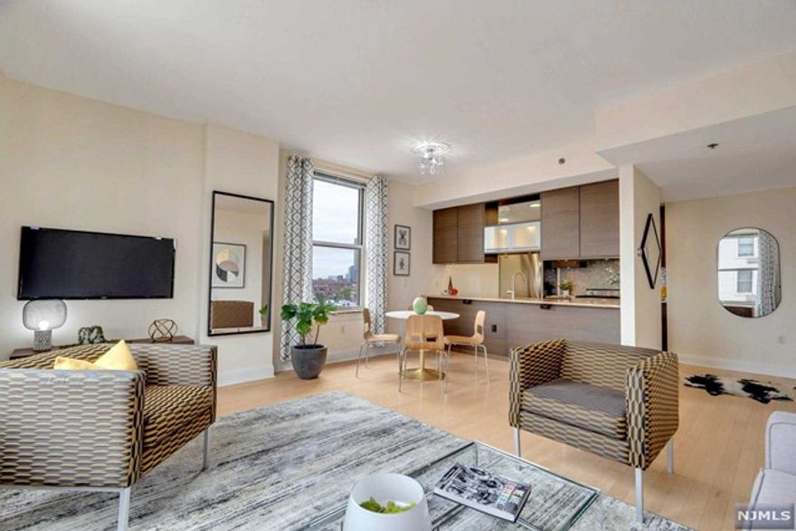 Welcome home to this rarely available Northwest 2 bedroom / 2 bath corner unit at full amenity building, The Sutton in Liberty Harbor! This beautiful home encompasses almost 1200 square feet, boasts an abundance of natural light, open concept floorplan, gleaming hardwood floors throughout, and views of the Jersey City skyline! Modern kitchen boasting granite countertops, double sink, stainless steel appliances and Viking gas range. Walk into the spacious primary bedroom with a gleaming marble ensuite bathroom and custom walk-in closet. Second bedroom is over sized with ample closet space. Washer and dryer in unit. The Sutton is a Full-Service Building with an Outdoor Pool, BBQ Decks, Jacuzzi, Gym, Playroom, Community Room, Theater, Game Room, full time Concierge. Parking available on site for additional fee. Prime downtown location, perfect to stroll to Liberty State Park or to Jersey City's beautiful and historic Van Vorst Park! Light rail with access to the NY Waterways