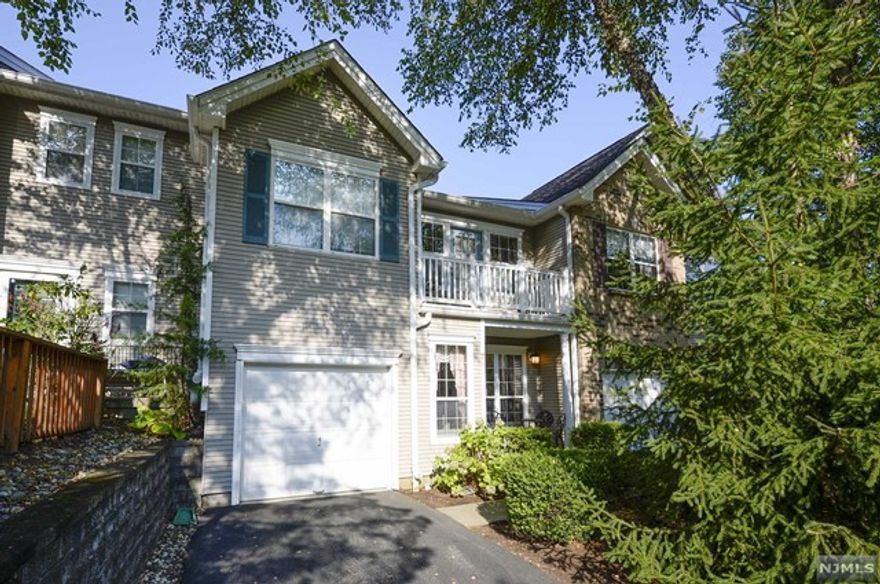 Discover this exquisite townhouse nestled in Mahwah's coveted Birchwood Hills Complex. Boasting 3 spacious bedrooms and 2.1 bathrooms, this updated home is awash in natural light, highlighting its stunning hardwood floors. Enter to a welcoming foyer that flows into a magnificent living room and elegant dining area. The family room, with its soaring ceilings and charming fireplace, adjoins a modern kitchen featuring granite countertops and ample cabinetry. Step onto the deck from the first floor to enjoy serene outdoors The second floor hosts a luxurious primary suite with a private balcony, soaking tub, dual sinks, and a standing shower. Two additional large bedrooms, a full bathroom, and a convenient laundry room complete the upper level. The renovated, fully finished basement offers a bonus room perfect for a home office and walkout access to another private patio. Enjoy premium community amenities including a heated pool, children's pool, tennis club, gym, clubhouse, & more!