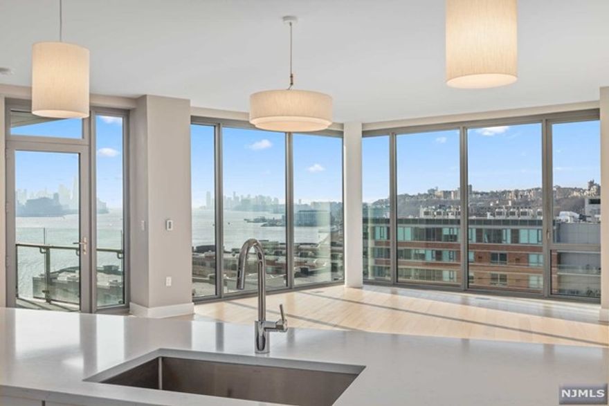 Welcome to Nine on the Hudson. Penthouse 8 is an incredible home with stunning direct east views of the Hudson River and NYC skyline. This luxurious 2 bedroom + Den, 2 bathroom 1,700+ sq. ft. residence has all high end finishes complete with floor to ceiling windows, balcony with views of NYC, beautiful hardwood flooring throughout and a stunning state-of-the-art kitchen, including Bosch appliances and Thermador refrigerator. Separate wet bar area off the living room with wine refrigerator is perfect for entertaining. Two full marble bathrooms contain Kohler fixtures and Restoration Hardware lighting. Bosch washer/dryer in unit. Amenities: doorman/concierge, business center, 2-story gym, sauna, playroom, resident lounge, golf simulator, party room, outdoor courtyard with BBQ and beautiful infinity pool. Shuttle to/from the Port Imperial Ferry. Unit includes 2 parking spots and 1 storage unit. Not to be missed!