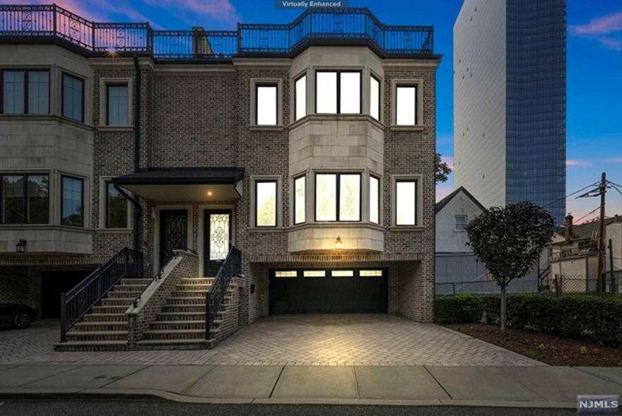 Rarely available Luxury and Location at its finest in the heart of Fort Lee NJ, this is a custom built 4 level masterpiece with 4 Beds 5 Baths with Radiant Heated floors in all baths + Elevator including a rooftop deck / entertainment level with views of GWB and NYC located on a quiet one way street with tons of privacy. This corner unit boasts 10' ceiling heights, custom hardwood floors, timeless custom moulding, gourmet chef's kitchen, central vacuum. Additional features include entertaining space on 4th floor Junior suite + Full bath with wet bar, fireplace, 3rd level: 2 bedrooms + hallway full Bath+ Grand Primary Suite w/ ensuite Full bath, 2 large walk-in closets + Washer/Dryer.. Main level features a gourmet chefs kitchen with an island for breakfast / large dining area + living room w/ fireplace. Ground level a bonus room for a gym with additional closets / 2 car garage and Elevator access. Close to shops/restaurants/theater, schools, highways + bus to NYC at your doorstep!