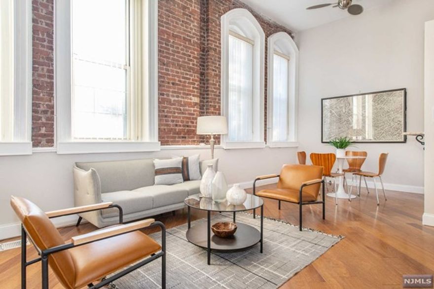 A terrific 2 bedroom condo with one full bath and a powder room. Enjoy this spacious duplex unit with two levels of luxurious living. With high ceilings, oversized windows, hardwood floors & exposed brick walls. Renovated kitchen with granite counters & stainless appliances, laundry in unit & updated bathrooms. The unit is among the largest square footage offered in this 16-unit historically significant building located in the Hat District of Orange. Includes two assigned parking spaces. Near to conveniences such as a CVS, a grocery store, a nail salon, and several contemporary restaurants. The train station is within a few blocks of this building while commuters also enjoy easy access to Rte 280. Welcome Home!