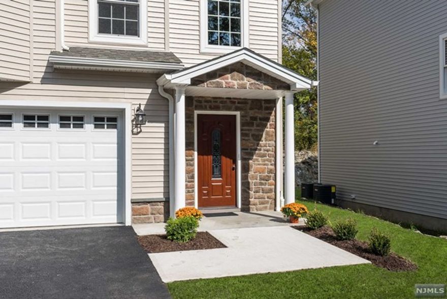 LIMITED TIME - BUILDER MORTGAGE RATE BUY-DOWN. BRAND NEW CONSTRUCTION BOUTIQUE 12 End Units. 3Br unit boasts over 3200 sq. ft. (includes garage), quality workmanship throughout. 3 finished levels, open concept floor plan on 2nd level w/amazing kitchen w/all the bells & whistles, cabinets to ceiling w/crown molding, huge center island that seats 5, quartz counters, dining area, under cabinet lights, top of the line SS appliances & wine refrigerator! Oversized LR/DR combo w/electric FP, lots of windows that flood the space w/natural light. SGD to private deck overlooking woods. 3 large bdrms, Master features full bath w/luxurious shower & 2 spectacular walk-in-closets w/custom built-ins. 2 full & 2 half baths gives you a bath on every level. Beautiful wood floors throughout main levels. Ground level finished Family room w/ LPV floor and pwdr room. 10 yr Buildr warranty. Close to NYC bus.