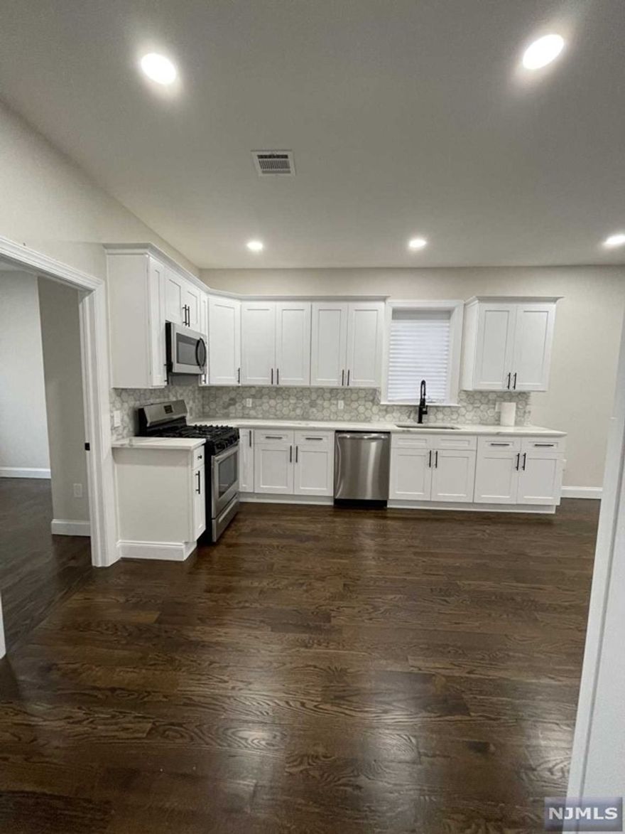 Brand new 3 family home. Be the first to live in this gorgeous 3 bedroom first floor apartment. Large Living and Dining Room. Eat in Kitchen with Stainless Steel appliances, Quartz countertops, Marble backsplash. Beautiful Full Bathroom. Washer/Dryer in unit enclosed in a closet with room for storage. Gorgeous hardwood floors throughout. Central AC/Heating; all new electric and plumbing; plenty of outlets throughout. Driveway parking for 3-4 cars included. No pets. No smoking.