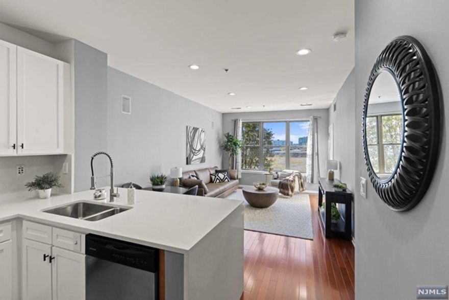 Welcome to this spacious 1 Bed / 1 Bath 740sqft condo located in the highly sought-after Hudson Club community. You'll immediately notice the SOUTH-facing views filling the space with natural light all day long and partial views of NYC skyline and Hudson River. The kitchen features brand new quartz, white cabinets, SS appliances, & a breakfast bar open to the dining & living room. The primary bedroom offers a spacious custom walk-in closet, a jack-and-jill balcony to enjoy the morning or evening breeze, & an en-suite bathroom w/new tile & mirror. Hudson Club's maintenance fees include water, gas, cable, internet, parking, & amenities; only pay for electric! In-unit W/D & indoor parking completes the home. Community offers an array of amenities for residents. Take advantage of the concierge, swimming pool w/jacuzzi, gym, basketball court, movie theater, fire pit, & lounge. Easy access to NYC via the ferry/bus, & ACME, Starbucks, restaurants & more conveniently located near by!