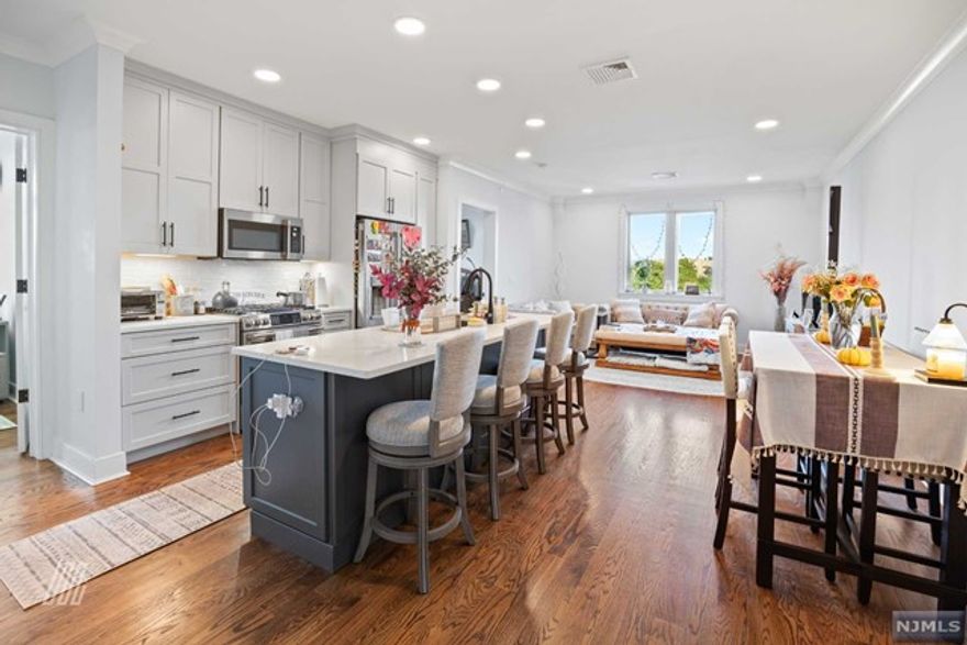 Presenting an exquisite condo in JC Heights, this splendid residence offers over 1,000 square feet of living space w/ 2 spacious BRs & 2 elegant BTHs. The interior features an open-concept layout seamlessly transitioning from the inviting living room to a well-appointed kitchen, boasting top-of-the-line SS appliances, sleek cabinetry & ample countertop space. Natural light floods through large windows, creating an airy atmosphere. The primary bedroom includes an en-suite bathroom, while the 2nd bedroom offers versatility as a guest room, home office, or personal sanctuary. Both bathrooms have contemporary finishes, evoking a spa-like ambiance. The unit also features in-unit WD, an energy-efficient tankless water heater, a smart NEST thermostat & a huge walk-in closet. Enjoy NYC views from your window or the building's rooftop deck. With a deeded parking space, indoor bicycle storage, and a secure package room, commuting is easy with Citi bikes and express buses right outside.