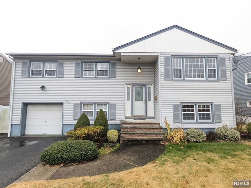 Amazingly clean & updated 4 bedroom, 2.5 bath home! Quiet street w/ off street parking and attached garage. Gas stove & Heat, central AC. Large backyard w/ privacy fence. Hardwood floors throughout. Rec room on ground level w/ walkout sliding doors to outdoor patio. Close to all shopping, major highways, NYC transportation, & schools. Don't miss out on this opportunity!