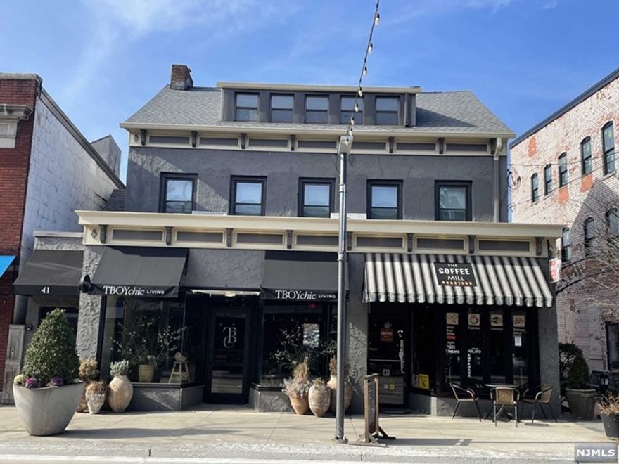 Prime downtown Millburn location - rare opportunity to own an updated and beautifully maintained investment property in the center of town. Just one block to train to NYC! Building is fully leased with four total units: two stores on the ground floor and two 2-bedroom apartments on the 2nd and 3rd floor.