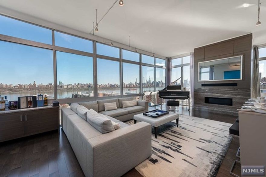 Manhattan style living brought to you bigger and better on the Gold Coast of NJ. One of only a few elusive penthouses at One Hudson Park, this unit is unparalleled in design, views, and updates. Completely renovated after purchase with wood floors throughout, Elan smart home system and LeGrand lighting. Master Bedroom closet designed after Kiton boutique on 5th Ave. Large floor to ceiling windows from living area to dining room with breathtaking views of the Hudson River and NYC skyline. Kitchen with Gagengeau and wolf appliances. Warming drawer and wine cooler. Outdoor terrace to take in the beautiful spring and summer weather coming our way. Condominium building recently underwent large renovation to their lobby and communal areas. Building offers pool, gym, playroom, garage parking and rooftop.