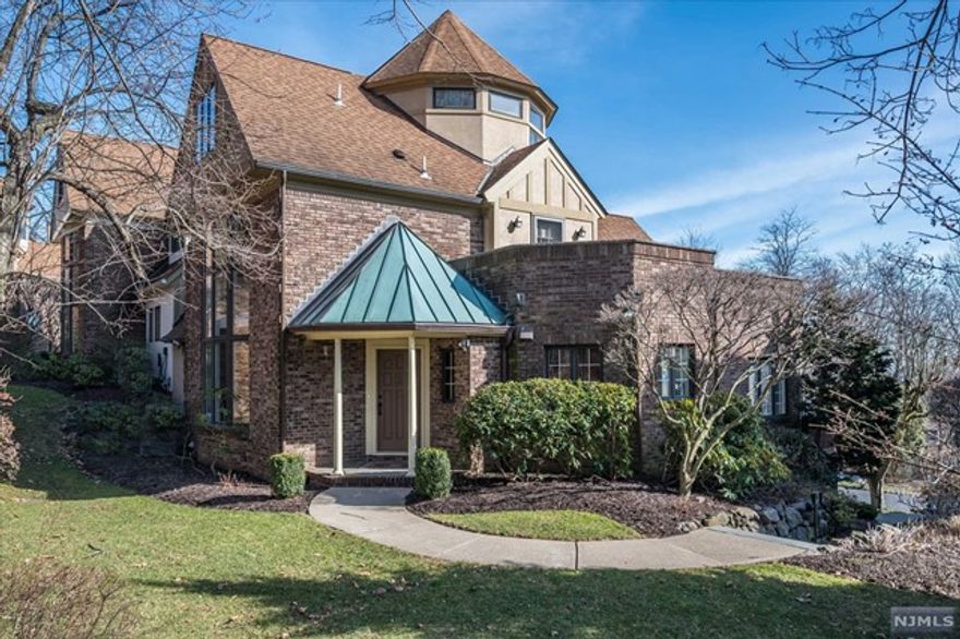 Welcome home to this exquisite 5 bed, 6 bath townhouse in a private enclave, offering a unique and sophisticated living experience. Bathed in natural light within a quiet, park-like setting, this home strikes the perfect balance between open and private spaces with seamless flow throughout and even its own elevator. Behind the elegant twin curved staircases is a gracious, sunken living rm featuring a gas fireplace and floor-to-ceiling windows leading out to a deck with a large seating/dining area. The eat in kitchen boasts both island seating and table space for six, Wolf double ovens,6 burner Wolf stovetop, Subzero refrigerator/freezer, and extensive storage space. A separate open dining rm is flanked with windows and accommodates large dinner gatherings.The main floor primary suite is magazine worthy with gas fireplace, gorgeous full bath w/double sinks, large shower, soaking tub.2 cat attached garage.This home has it all and is super close to all Montclair has to offer!