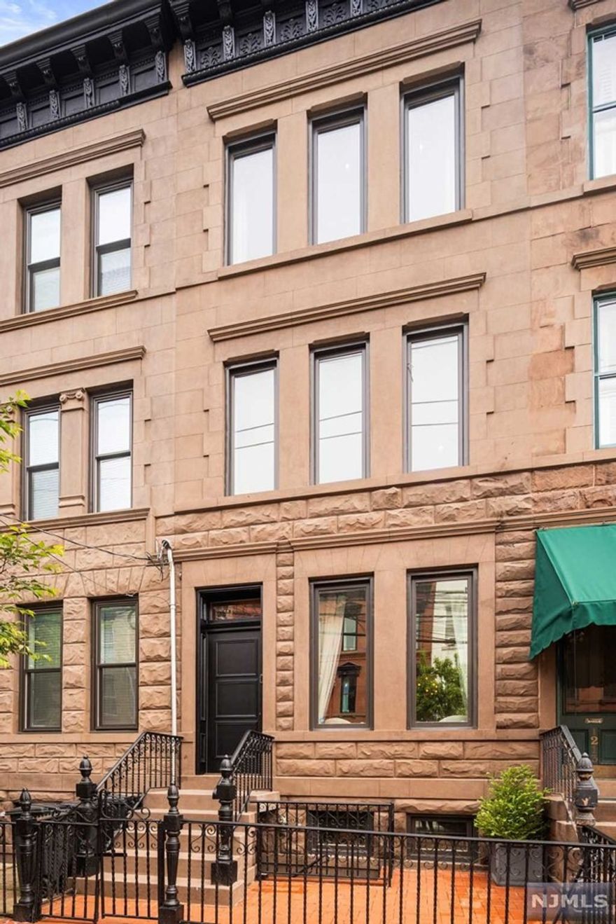 This stunning three-window-wide uptown Hoboken single family Brownstone has four bedrooms, a den and three bathrooms over four floors. This turn-key home has been thoughtfully renovated with an abundance of custom built-ins, well laid out rooms and a beautiful custom kitchen. This home is the perfect combination of original features and modern upgrades and it all starts on the parlor floor with an inviting living/dining area with 10' ceilings, crown molding, recessed lighting, a wonderful wood-burning fireplace with marble mantel, gorgeous oak hardwood flooring and built-in bookcases which lead to a fully equipped kitchen featuring luxurious stone countertops, custom cabinetry and top-of-the-line stainless steel appliances including a 48' Wolf dual oven with custom range hood, Subzero refrigerator, Miele dishwasher and wine fridge. The 1200 Block of Park Avenue retains desirable and consistent turn-of-the-century townhouse architecture and is located near transit options.