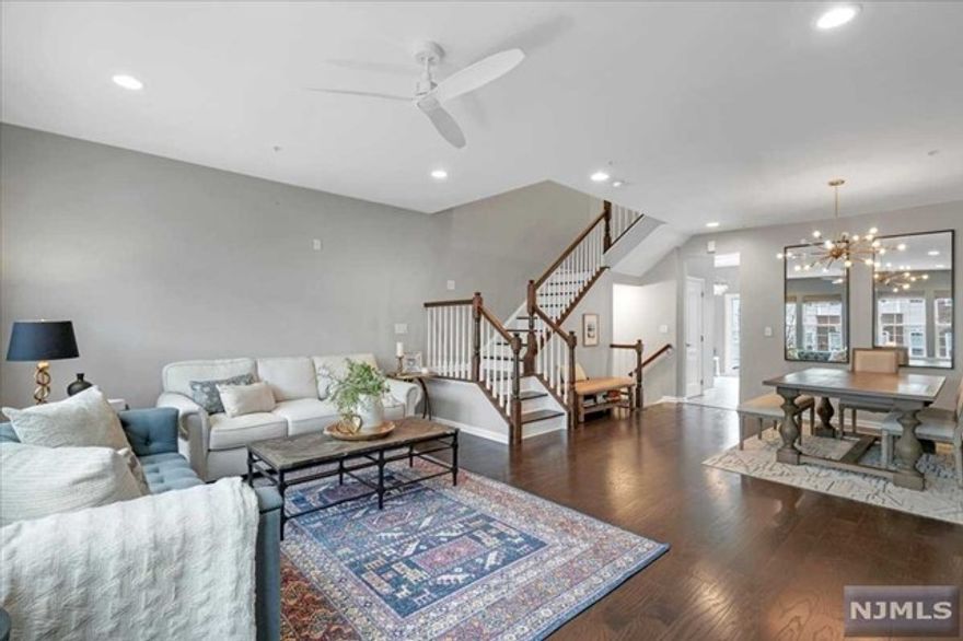 A rare layout in the desired community of Liberty Square at Wesmont Station awaits its first tenants. The location offers a CONVENIENT LIFESTYLE & is a COMMUTER'S PARADISE. This charming & chic townhome boasts 4 bedroom, 2.5 bath with 4 CAR PARKING (2 attached garage & 2 on driveway). Upon entering, witness spacious entry foyer, impressive tall ceilings, multiple windows & thoughtfully designed spaces. With approx 2,000sqft of living space, the home offers gleaming hardwood floors, recessed lights, oversized living room, large outdoor entertainment DECK & BONUS FLEX SPACE. Enjoy cooking in your kitchen featuring SS appliances, large island, granite countertops, PANTRY CLOSET & ample cabinetry. Primary bedroom to boast a WALK-IN CLOSET & en suite of dual sink, stand-up shower & relaxing JACUZZI. Community perks: On-site NJ Transit train station, kids playgrounds, parks, athletic sports complex, walking tracks, coffee & wine shop.