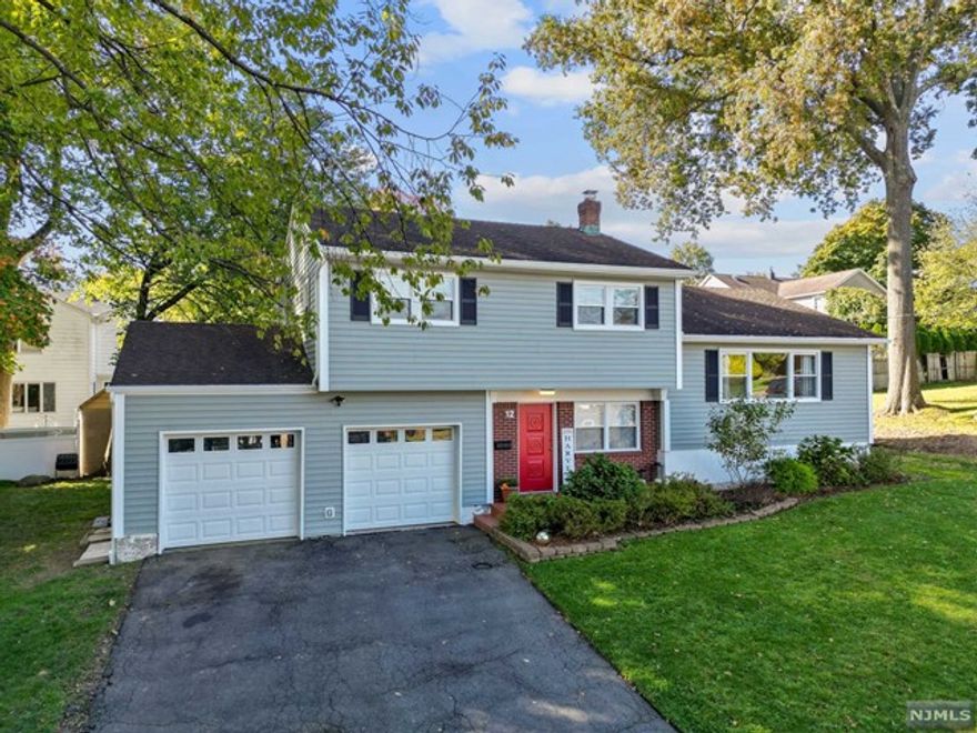 Available April 1st this beautiful home, nestled in a peaceful cul de sac, boasts an inviting foyer that welcomes you with and abundance of natural light. Step into the expansive living room with gleaming hardwood floors, recessed lighting, and an adjoining spacious dining room. Enjoy cooking in this modern kitchen with plenty of cabinets, granite countertops and SS appliances. Upstairs retreat to the primary bedroom with an en suite bathroom, 2 additional sizable bedrooms, and a full hall bathroom that complete this floor. The Lower level offers a family room with sliding doors that lead to a flat backyard and paved patio perfect for outdoor entertainment. There is a mudroom and a powder room situated just off the 2 car attached garage, ensuring easy access and functionality. The basement features laundry and plenty of storage. Conveniently located just 0.2 miles from the nearest bus stop, and 0.8 miles from the train station, commuting to NYC is a breeze.