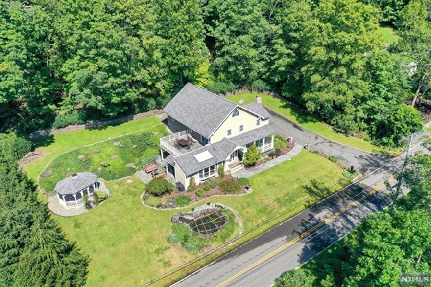 Does your dream home include over 2,500 sqft of gorgeous Craftsman charm, 2.57 acres of meticulously landscaped property, and golf course views? Then look no further, because this home has it all! Built in 1835, this home has been beautifully updated and pays homage to its timeless origin. First floor boasts eat-in kitchen w/Viking stove & stunning views, dining room, large living room with gorgeous stone fireplace & original wide plank wood floors. Upstairs has a 14x12 bedroom, a 19x12 room that can be divided into 2, w/French doors to a beautiful deck w/golf course views & 800sqft Master Suite w/vaulted ceilings, walk in closet & en-suite w/radiant heat & jetted tub. French doors lead you to a private Trex deck & bluestone patio. This serene property also features a gazebo, waterfall, koi pond, & stunning landscaping all within close proximity to mass transit to NYC, highways, shopping & more! BACK ON MARKET, BUYER COULDN'T PERFORM.