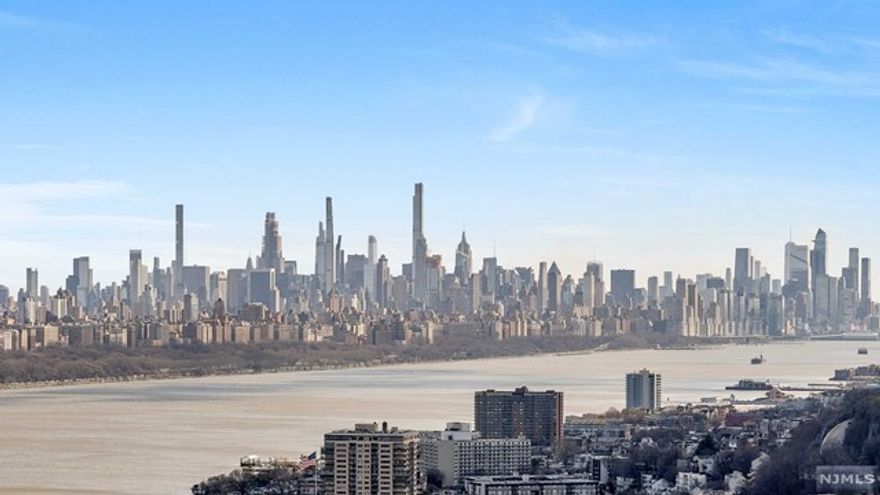 Outstanding opportunity for this sun-filled, corner residence with magnificent Hudson River and NYC Skyline views from every room. Stunning renovation includes solid hardwood flooring throughout and a custom kitchen with high end stainless steel appliances, wood cabinetry, tile backsplash and Quartzite countertops. Large center island hosts additional cabinetry and comfortably seats four. Wide open floor plan includes a bonus room from a terrace enclosure that can be used for either den, home office or spare bedroom. Primary bedroom boasts en suite bathroom with walk-in shower. Second bedroom is also generous sized, with ample closets throughout, all with custom built-ins. Premier luxury building offers many amenities, including 24-hour doorman and concierge, heated outdoor pool, kiddie pool, fitness center, BBQ grills and much more. Well located near good schools, shopping, houses of worship, and easy transportation to NYC. Parking $90. Subject to Board Approval.