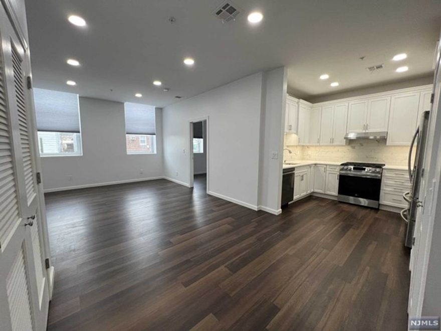 Gorgeous, modern, NEW CONSTRUCTION apartment just built and NEVER LIVED IN! Spacious, light & bright open floor plan with oversized windows that let in lots of natural light. Quartz counters in kitchen with plenty of cabinet space including spice rack and lazy Susan-all with soft close, plus high-end print-proof stainless appliances including dishwasher with third rack, convection oven with air fry and griddle on stovetop, and French door fridge with ice maker. Dedicated dining room space (or use as home office). Full bath features marble counters, soft close vanity, medicine cabinet and shower over tub. Plenty of closets throughout including walk-in pantry. Use of attached garage with direct access to apt for no extra fee! Plus, convenient laundry on-site and 24HR security cameras for your peace of mind. Close proximity to shopping, NYC bus & train station, schools and parks! NO pets/NO smoking. Credit/background check required. Tenant pays gas and electric, Landlord pays water.