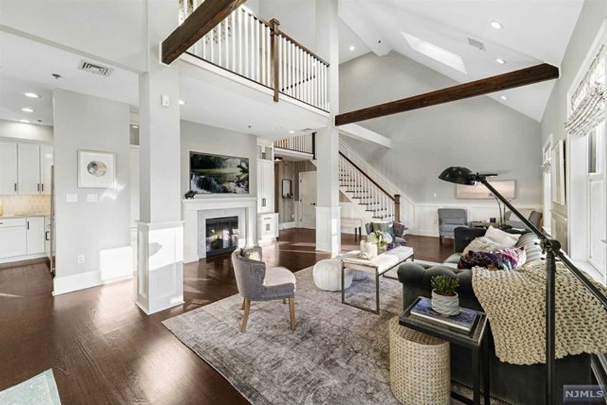 Impeccably renovated, custom designed 2405 square foot DUPLEX LOFT ideally located in midtown Hoboken. PH5A is an expansive, sun drenched 3 bedroom/plus den home, with 3 full baths, boasting 20 foot ceilings, architectural beams, skylights, wide plank oak floors, 5 walk-in closets, and custom built-ins throughout. Featuring a chef's kitchen with custom cabinetry, pantry, quartz countertops, ceramic tiled backsplash, and center island with wine cooler and bar sink, complete with top of the line stainless steel appliances including Wolf Range with vented hood, GE Monogram refrigerator, GE Profile Convection/Microwave oven and dishwasher. A gracious open floor plan allows for entertaining in grand style, cozying-up in comfort in front of your fireplace surrounded by beautiful built-ins, or stepping out to watch the sunset from your large terrace. The bathrooms are superbly appointed with glass designer tile and fixtures.