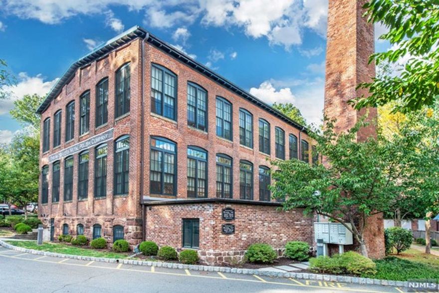 Prepare to let the loft lifestyle capture you in this amazing converted factory turned chic condo. Formally a metal polishing company, transformed into an industrial, art inspired loft you will feel the rich history and personality. Indulge in the original red exposed brick walls & factory wooden beam ceilings. Layout offers complete functionality with space for entertaining; soaring high wooden beamed ceiling, massive picture windows and loft visibility from the living room. Truly it pairs the beautiful bones of its origins with an impeccable renovation. The interior was designed with a modern aesthetic, high-quality finishes, SS appliances & a unifying sense of space & storage. Looking for a quick commute to the city? Well, CHOO-CHOO for YOU! Be captivated by a short walk to a mid-town train, amazing restaurants, Glen Ridge community pool, fitness centers and a hustling & bustling downtown Montclair.