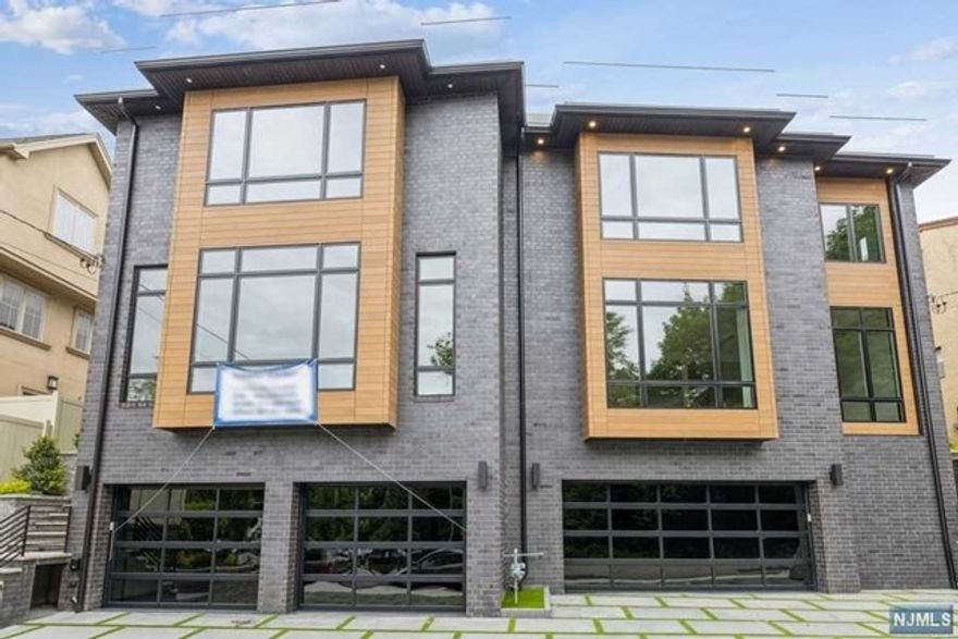 MAGNIFICENT 4 LEVEL STATE OF THE ARTS TOWNHOUSE, WITH 13 FT. CEILINGS IN LIVING ROOM, & 4 FLOOR ELEVATOR. HUGE WINDOWS. KIT WITH CENTER ISLAND AND THERMADOR APPLIANCES. RADIANT HEAT IN THE KIT, DR, ALL BATHS, BSMT AND GAR. MASTER SUITE W/2 WICS. DBL SINKS, STALL SHOWER & BATH TUB. 2 OTHER BRS HAVE OWN BATHS. KOHLERS FIXTURES, 2 FPLCS LR AND TOP FLOOR. TOP FLOOR W/ REC.RM. 1BR, 1BATH, STORE RM, WET BAR, FPLC, AND LG. ROOF DECK WITH NYC VIEW. PAVER DRIVEWAY AND LG. REAR PATIO. NEAR NYC TRANS. OVER 5000 SQ.FT. MAKE OFFER.