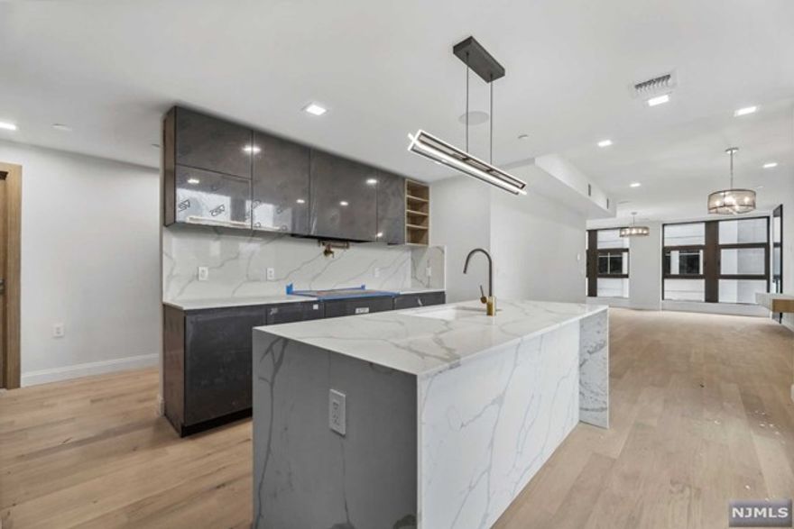 Welcome Home to 72 York Street - Luxury Living in DTJC. An exquisite 11 story, 14 unit residential condominium building nestled in the heart of DTJC . This stunning 3 bed/2.5 bath unit offers low HOA and a total of 1,908 sq ft of well-designed living space, providing the perfect blend of comfort and sophistication. Step inside and be greeted by the refined interior, where no detail has been overlooked. Large windows fill the unit with natural light that gleams off the engineered hardwood floors. The kitchen is a chef's dream, featuring top-of-the-line appliances from Cafe, finished in brushed bronze. The cooking range, microwave, and wine cooler are designed to blend seamlessly with the kitchen's elegant aesthetics. The three bedrooms are designed to provide ample space and comfort, ensuring a peaceful and restful retreat.The spacious living room provides access to a 42 sq ft balcony. 72 York st boasts an array of thoughtful features located in PS 16 school district.