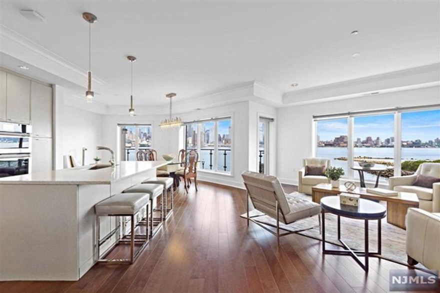 This one of a kind, voluminous 3 bedroom, 3.5 bath, corner residence is sure to please with it's direct East & South unobstructed panoramic views of NYC from all rooms. Be left in awe from the peacefulness of the water & skyline from your over-sized balcony, wrapping from your master bedroom to your living room. The marvelous chef's kitchen is equipped with top of the line Jenn Air appliances, including French door refrigerator, Pro Style Gas cook tops, European style Spazzi custom cabinetry with polished chrome hardware. The south-facing master suite is outfitted with a walk-in closet and en-suite bathroom with a walk-in shower and soaking tub. The home further features, hardwood floors, 2 car garage indoor parking, full size whirlpool front load washer & dryer, and much more. Community offers concierge services, club room, theater room, children's play studio, an outdoor patio with fire pit, swimming pool and much more! Do not miss your opportunity to own this view today!