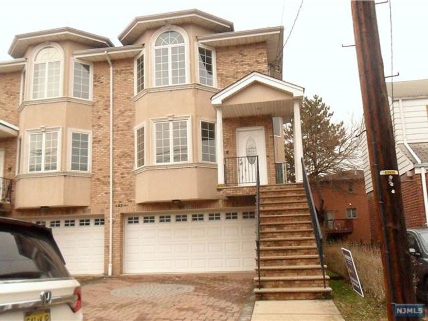 WELCOME TO THIS SUN-FILLED DUPLEX ON NICE RESIDENTIAL STREET. THIS AIRY AND SPACIOUS UNIT HAS GREAT OPEN LAYOUT WITH MODERN KITCHEN/ISLAND. FRESHLY PAINTED AND NEW BATHROOM VANITY PUT IN IN THE MASTER BATHROOM. LOWER LEVEL HAS FAMILY ROOM WITH SUMMER KITCHEN & 2 CAR GARAGES. LOCATED SOUGH AFTER STREET CLOSE TO SCHOOL AND NYC BUS STOP.