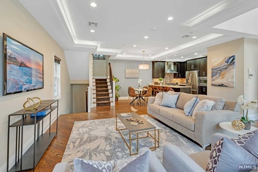 Luxurious end unit townhome located at the Marquis on the Hudson with NYC & water views. This exclusive gated townhome community offers beautiful homes along the riverfront w/ desirable open floor plans, high ceilings, and hardwood floors. Enter through a private entrance into the light-filled first floor with a high-end kitchen featuring granite countertops, an island w/ seating, stainless appliances, a generous dining area, powder room, and a family room w/ tray ceiling and cove lighting. On the second floor, the stunning master suite boasts a tray ceiling, large windows, an expansive walk-in closet, as well as a sliding glass door to a spacious balcony. Spacious 2nd bedroom, large open loft area, laundry, and a full bath complete this level. Access to the Hudson river walkway. Use of amenities at neighboring Independence Harbor including pool, gym, playground & tennis courts. Incredibly convenient location near shops, restaurants, light rail, ferry access and more.