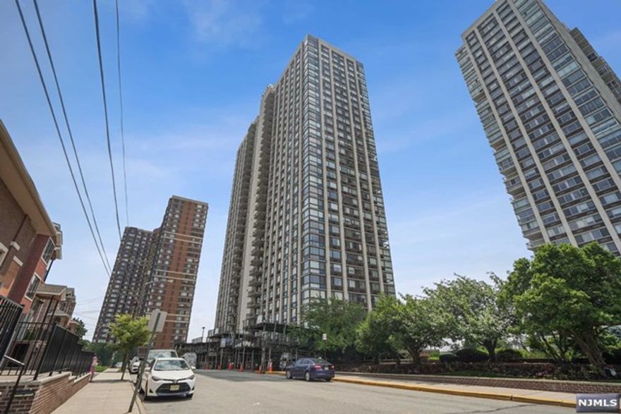 AMAZING EXPOSURE LUXURY HIGH RISE CONDO IN FULL SERVICE AMENITY BUILDING! VERY SPACIOUS CORNER UNIT W/RIVERVIEWS OF NYC, HARDWOOD FLOORS THROUGHOUT,EVERYTHING UPGRADED AND HIGH END APPLIANCES, TOP OF THE LINE CUSTOM CABINETS W/GRANITE COUNTER TOPS..TWO PARKING SPACES AND EXTRA STORAGE BIN INCLUDED. VERY CONVENIENT PREMIER LOCATION ONLY MINUTES FROM NYC BUS STATION, CLOSE TO SHOPS AND RESTAURANTS!!! PLEASURE TO SHOW!!!