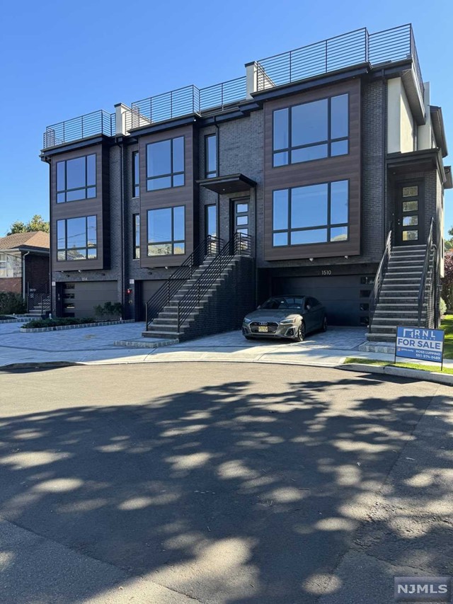Oversized townhome in the perfect, quiet location in the very desirable town of Fort Lee! Sitting on the end of a quiet, cul-de-sac road, this brand new modern triplex features 3 large bedrooms, 5 bathrooms, sleek open concept designs, 9 ft ceilings, large rooftop terrace, with rec room + wet bar & half bath. LED lighting throughout the entire home, built in security camera system + 10 ft kitchen island surrounded by LG kitchen appliances and impressive quartz countertops. Porcelanosa tile throughout. Large ground floor level with direct access to yard. Master bathroom features large shower with floor to ceiling tile, LED lighting, double vanity with lighted mirrors and spa-like floating tub. Minutes away from all Fort Lee has to offer.