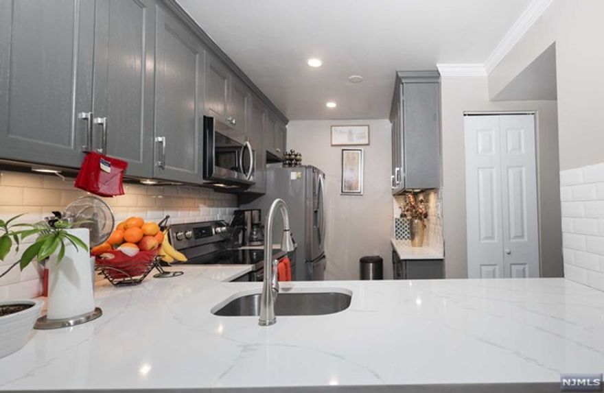 Captivating and Updated Condo in Newark! Centrally located in the desirable community of Forest Hills, this 2BR/1BA, 998sqft top-floor unit warmly welcomes with gorgeous wood flooring, tons of natural light, a neutral color scheme, an openly flowing layout, vaulted ceilings, crown molding, and a large living room with a wood-burning stone fireplace. Renovated to interior design perfection, the open concept kitchen features stainless-steel appliances, ample gray cabinetry, solid surface countertops, recessed lighting, a built-in microwave, and a dining area. Both bedrooms are generously sized for accommodating comfort, while the primary bedroom also has a deep closet. Enjoy elevated self-care routines in the newly renovated full bathroom boasting dual sinks. Other features: parking space, private balcony, oversized skylight, central A/C, forced heat, storage throughout, close to shopping, restaurants, entertainment, schools, and much more! Call now to schedule your showing today!