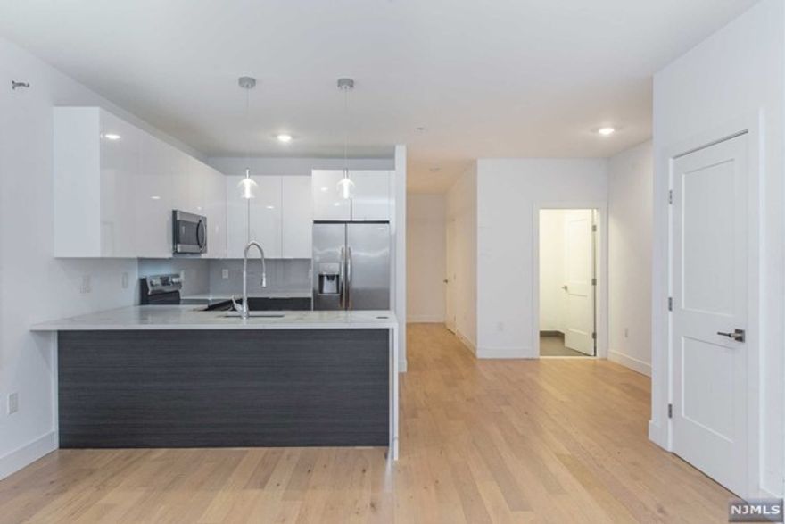 Welcome to Apt 403 at Le Parc in North Bergen. Located along the gold coast of New Jersey, this gorgeous open floor plan 2 bedroom, 1.5 bath unit is available for immediate occupancy. Situated in North Bergen's highly sought-after Woodcliff section, this unit truly has it all. Spacious 1,140 square feet with luxury finishes such as high-efficiency windows, LED lighting throughout, oak hardwood floors, video intercom system, and PTAC heating and cooling. No detail left untouched! 9 ft high ceilings, laundry in unit, fully upgraded kitchen with stainless steel appliances, breakfast bar, and quartz counter tops. Meticulously kept elevator building with parking garage! Don't miss this excellent opportunity to live less than 5 miles from NYC. BROKER FEE PAID BY LANDLORD! No security deposit for well-qualified tenants through Rhino. Parking additional $75 monthly. Pet friendly building.