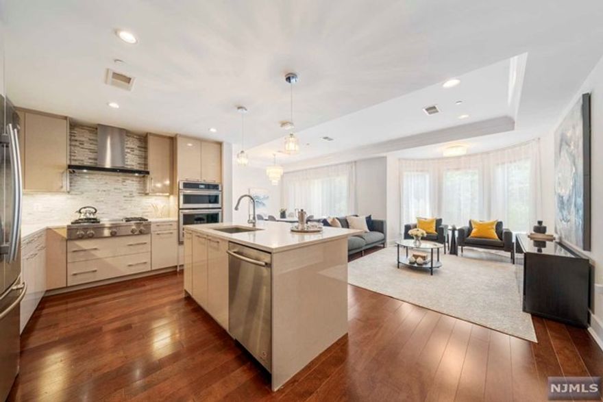 Welcome to Henley on Hudson 100 Eton Row- Residence 303, a captivating west facing residence boasting a split two-bedroom layout with two full bathrooms. Designed for both relaxation and entertainment, the expansive open-concept floorplan seamlessly connects a spacious living and dining area, adorned with large curved wall of windows in the living room that dominates the space. The open kitchen is a chef's delight, featuring large center island, chic quartz countertops, and top-of-the-line stainless steel JennAir appliances.The primary bedroom boasts a huge walk-in closet and a spa-like en-suite bathroom with a wet room and a spacious double vanity. The second bedroom has a large closet and easy access to a pristine second bathroom. One deeded garage parking space complete the home. Henley on Hudson features world-class amenities including concierge, pool with jacuzzi, fitness centers, movie theatre, kids' playroom, social room, and shuttle to/from Ferry and Lightrail station.