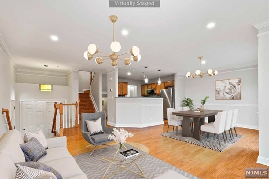 Just Renovated !This gem is SOHO CORNER unit offering extra windows w/ southern exposure to waterfront views & the Sun shining bright all day in the front.Be welcomed by gleaming hdwd flrs in foyer,Living rm,formal & informal dining area w/ sliders opening in to the balcony great for entertaining. Kitchen is adorned w/granite countertops, big pantry for storage & brand new appliances. Upstairs you have cathedral ceilings & beautiful sunset views by the water from the comfort of your bed.Laundry hook ups on same flr for convenience. Bright Spa like bath w/ big windows, soaking tub & stand up shower. Good size 2nd bedroom & full bath. Downstairs ground level is alarmed garage & a huge entertainment room w/slider doors opening into your private concrete patio & shared backyard.15 mins to NYC this house is the perfect combination of suburban living w/ access to great schools, amenities, parks, stadium & last but not the least the Mall of America. This unit is easy walk to the pool.